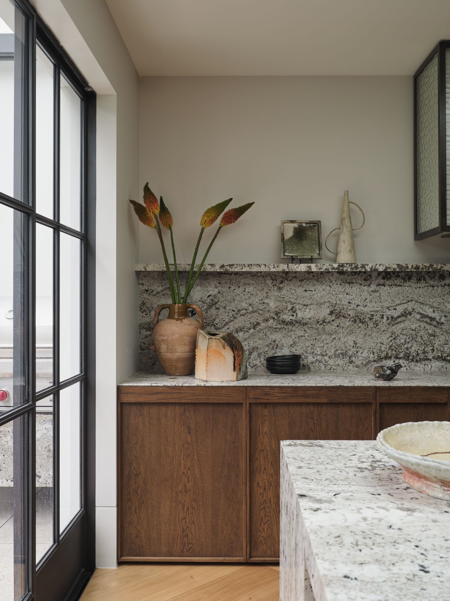 Monsieur G - Kitchen with walnut timber and grey green granite bench top and splash back 