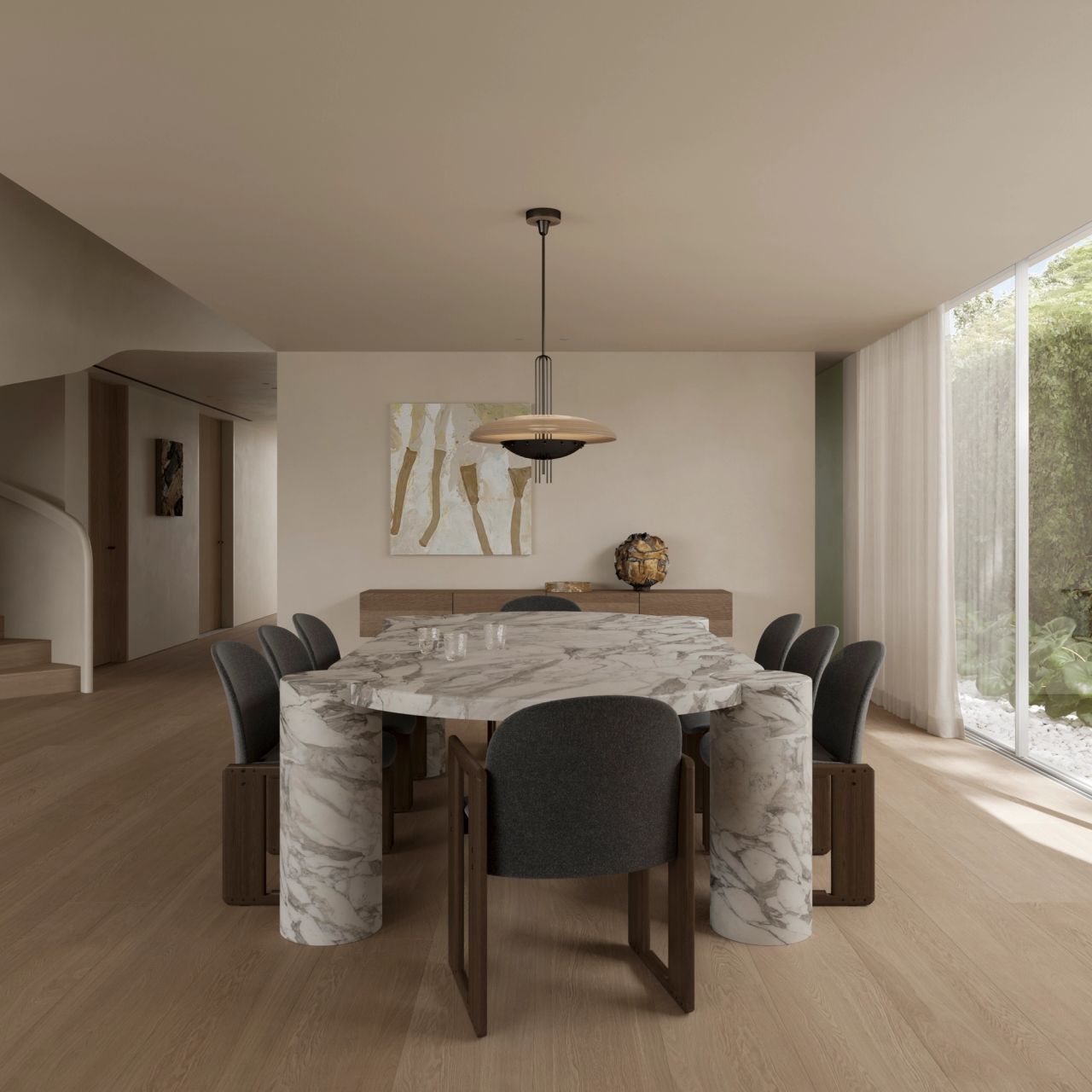 Park Dining room with a marble-clad octagonal table on cylindrical bases, dark upholstered chairs, a pendant light, and floor-to-ceiling windows overlooking greenery, with a curved staircase visible beyond.