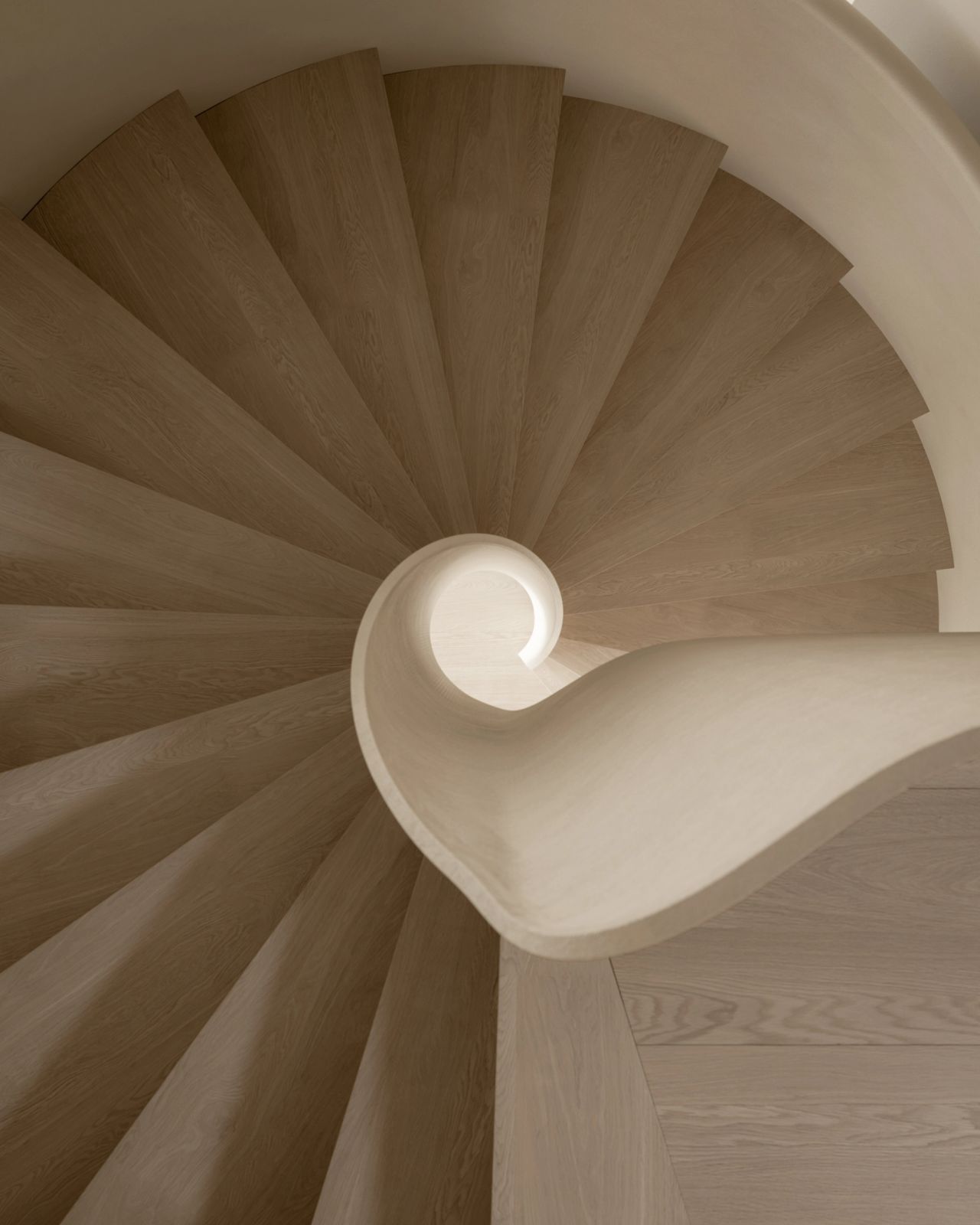 Sculptural staircase with curved balustrade and wide natural oak treads, viewed from above in contemporary neutral interior.