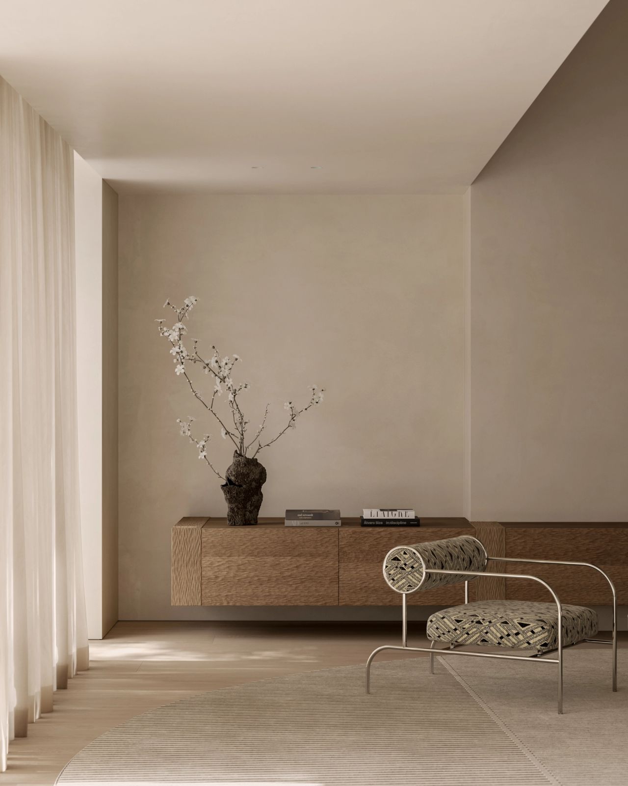 Warm neutral living room with textured timber joinery, sculptural patterned armchair, sheer curtains and soft natural light.