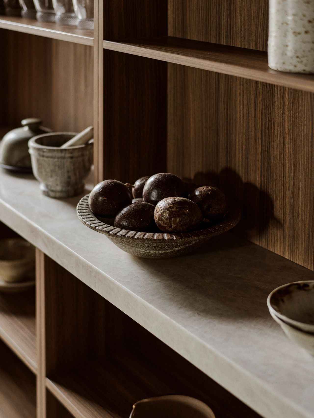 Orla contemporary butler's pantry with Brazilian-influenced dark timber joinery and shelving, styled with ceramics and glassware