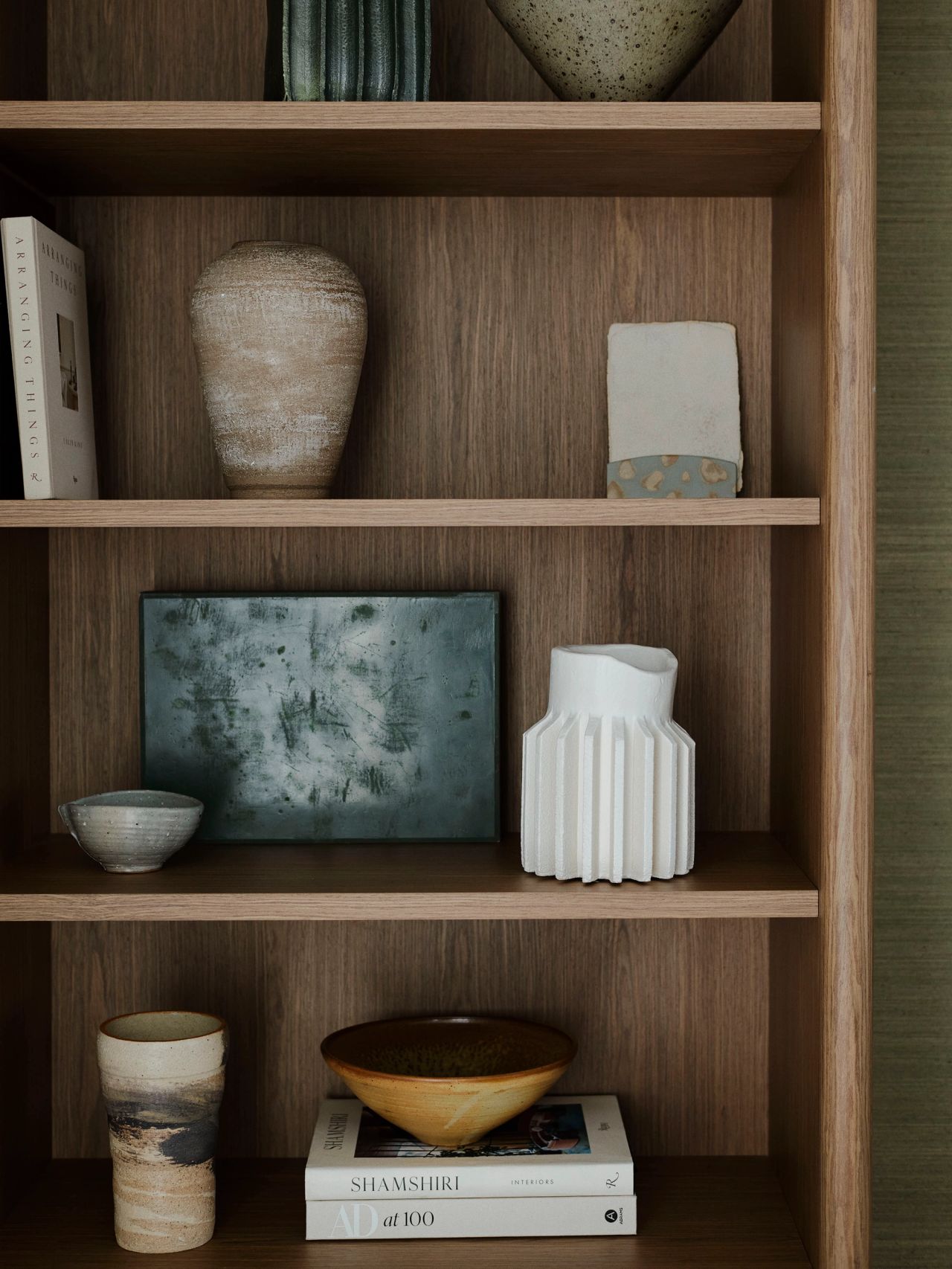 Bespoke timber shelving styled with handcrafted ceramics, art objects and design books.