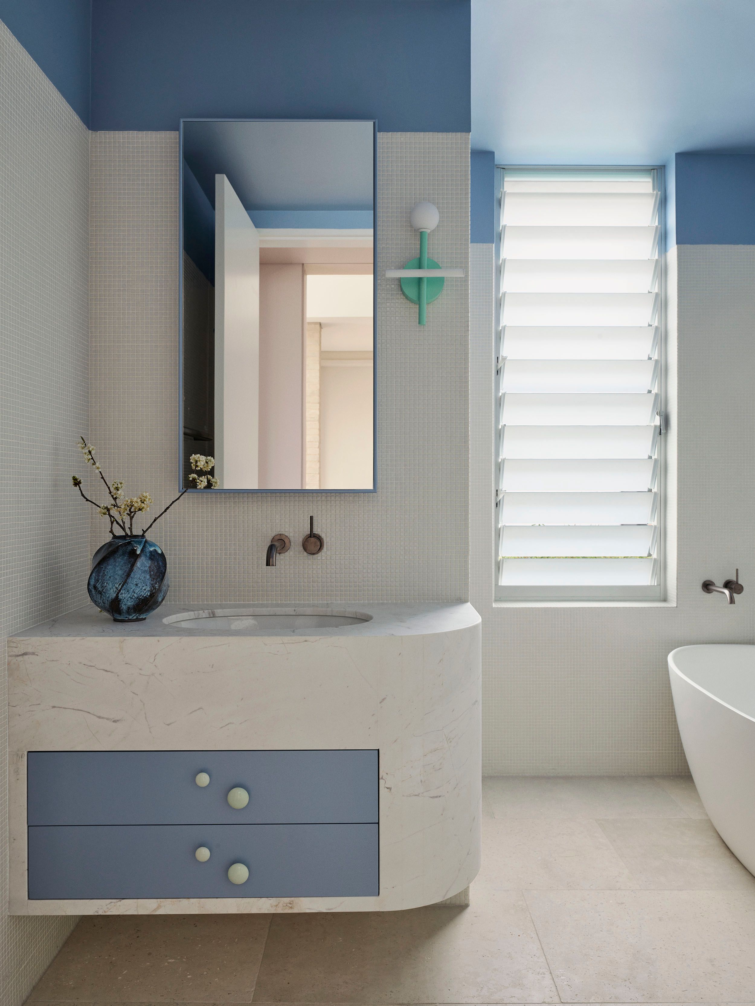 Light blue bedroom interior by Decus, featuring tonal blue walls and carpet.