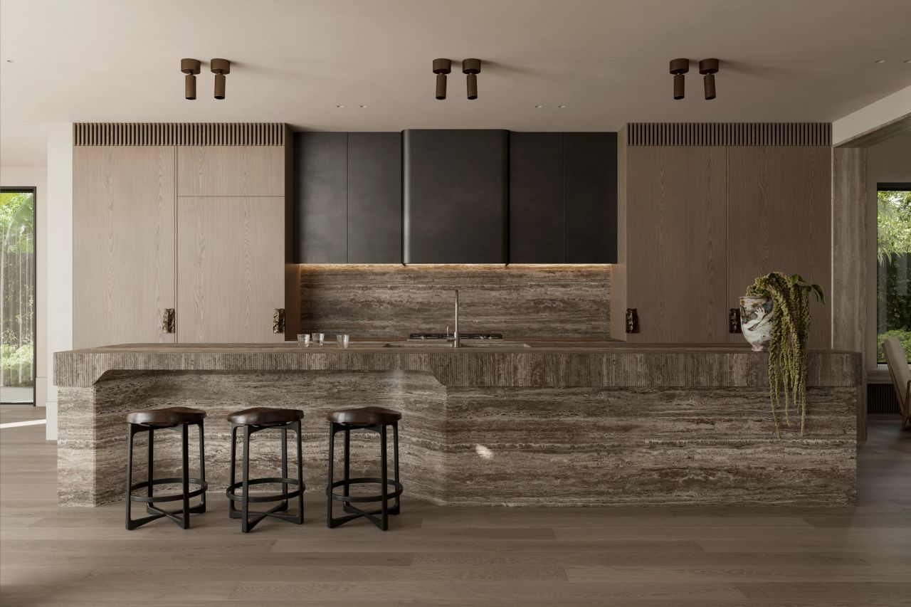 Heavy Metal Kitchen with a fluted travertine island bench and matching splashback, dark bronzed upper cabinetry with under-lighting, timber joinery, three timber and black-metal bar stools, and a trailing potted plant on the benchtop.