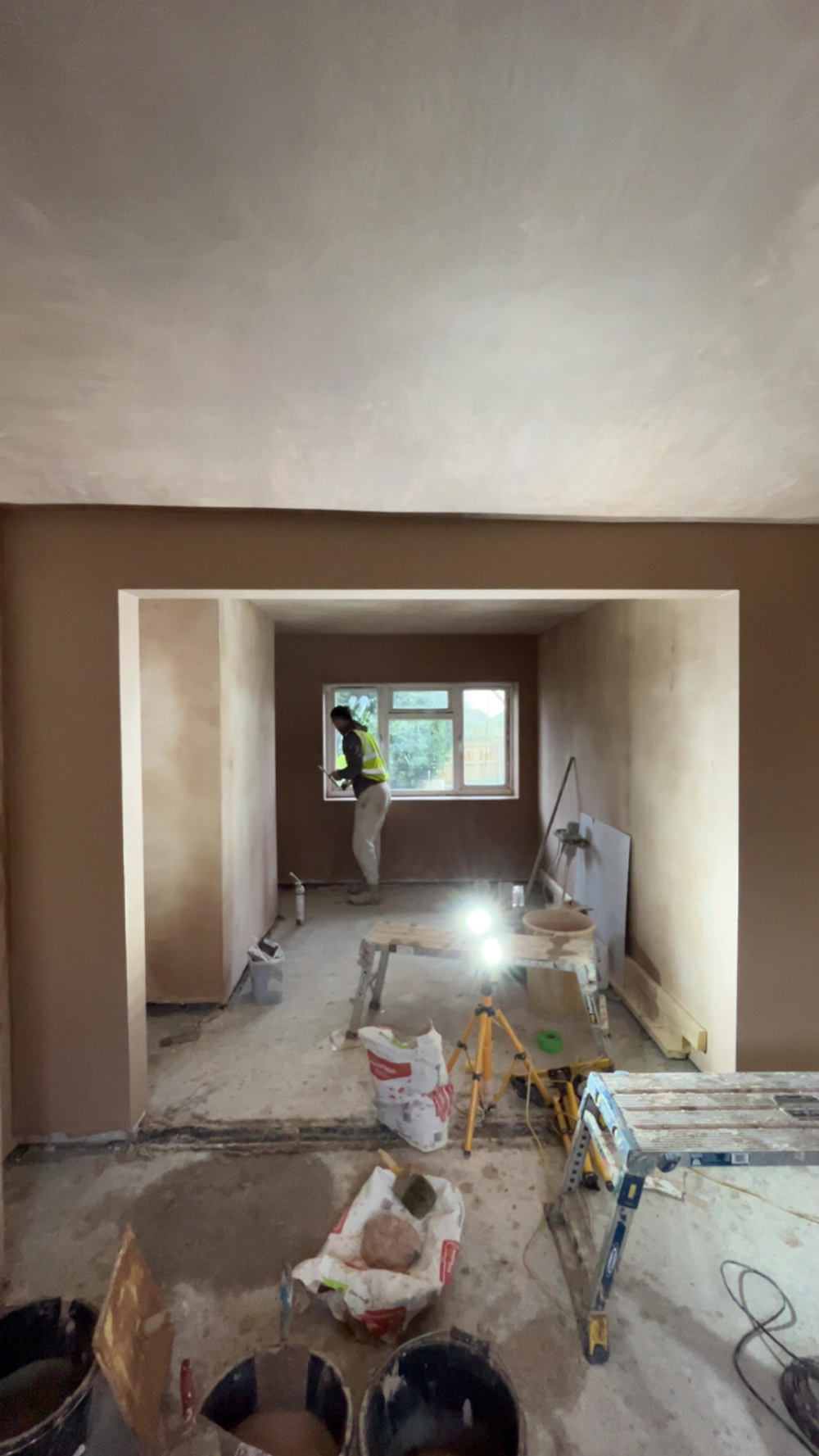 Room with a newly formed window opening plastered around it