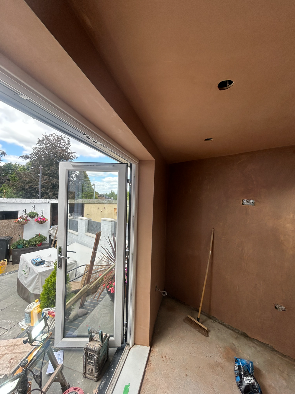 Room with a large picture window, plastered