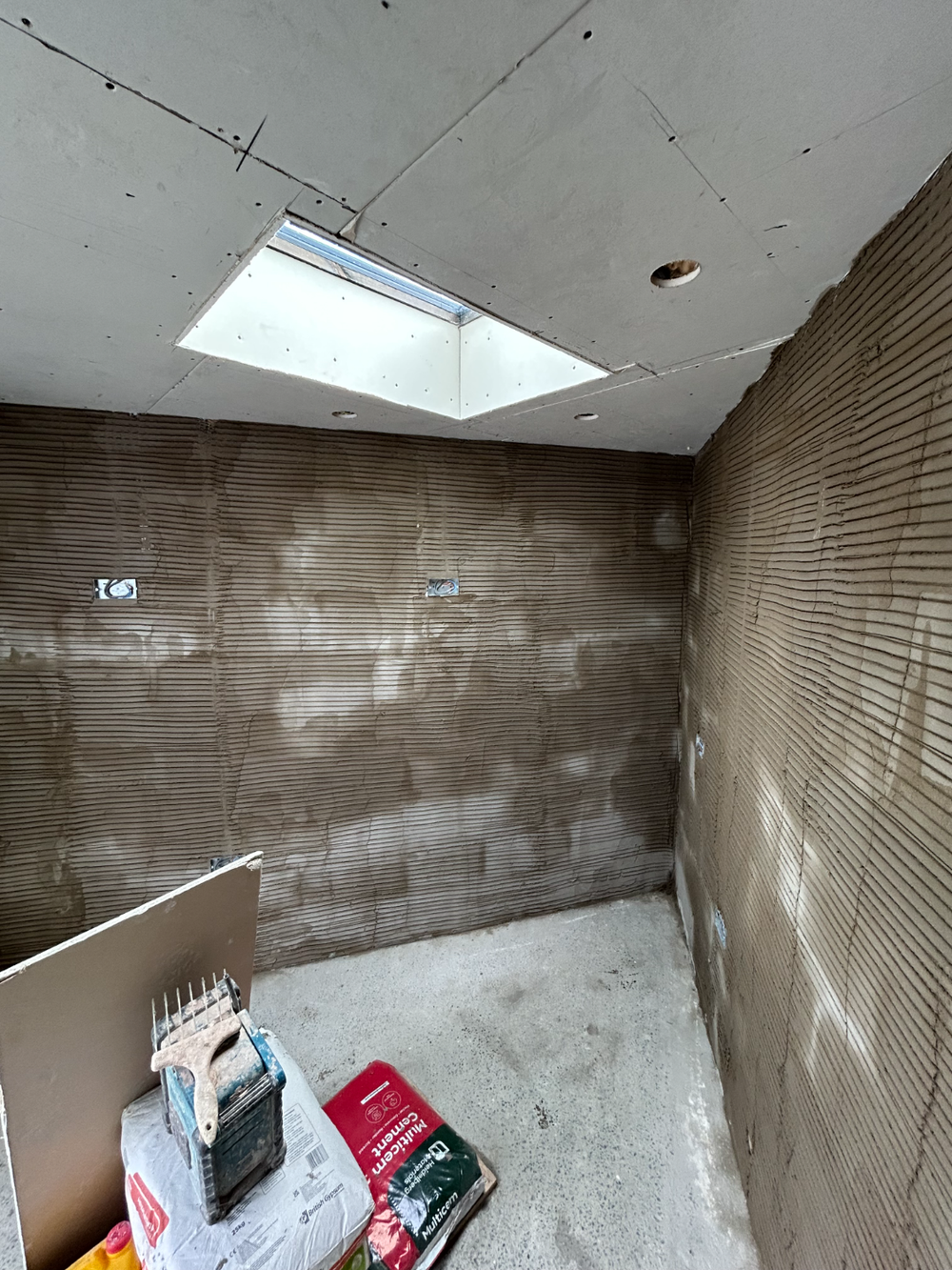 Corner of a room in backing coat below a skylight