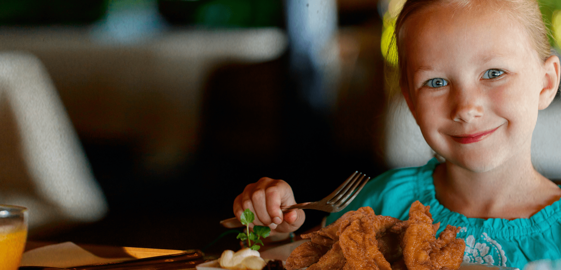 A young guest digging into dinner at Gator's