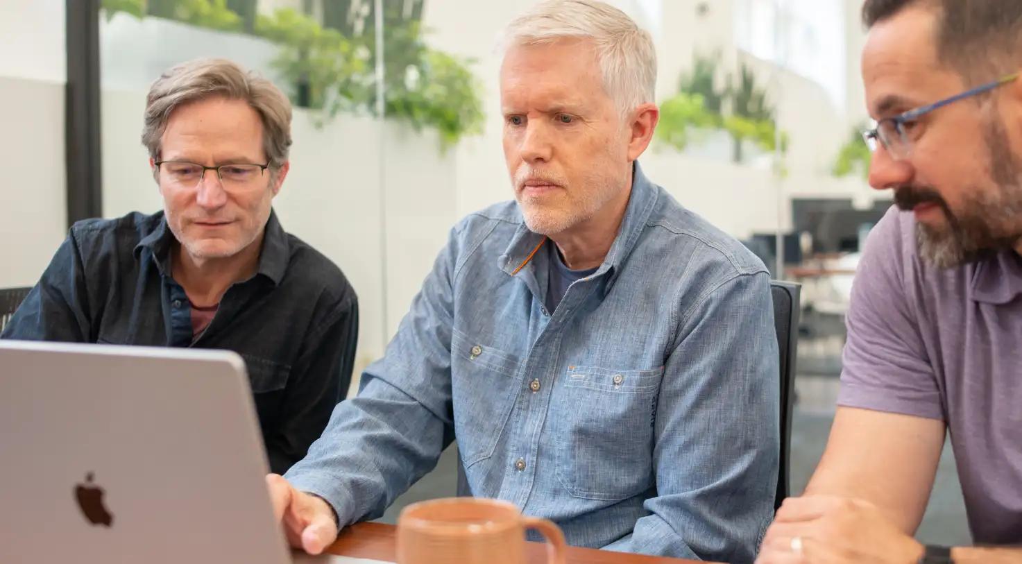 serious men looking at a computer