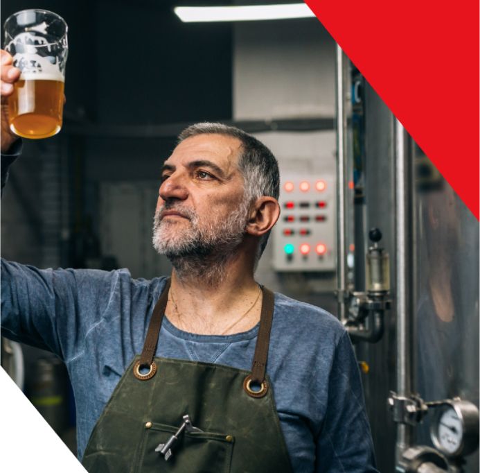 A man holding a glass of beer