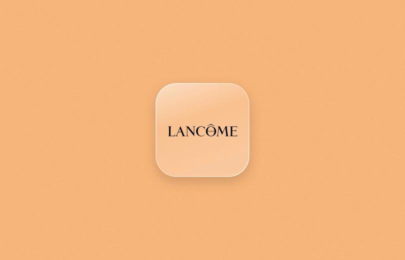 Lancôme logo on a frosted glass tile over a peach background