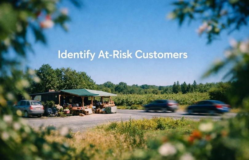White text reading “Identify At-Risk Customers” over a soft gradient background.
