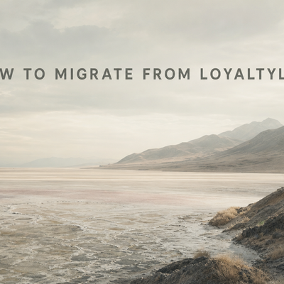Minimalist landscape with "How to Migrate from LoyaltyLion: Complete Step-by-Step Guide" text rendered in the sky, representi