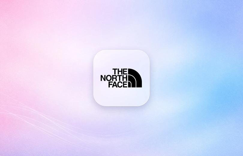 The North Face logo on a frosted glass tile over a soft pink and blue gradient