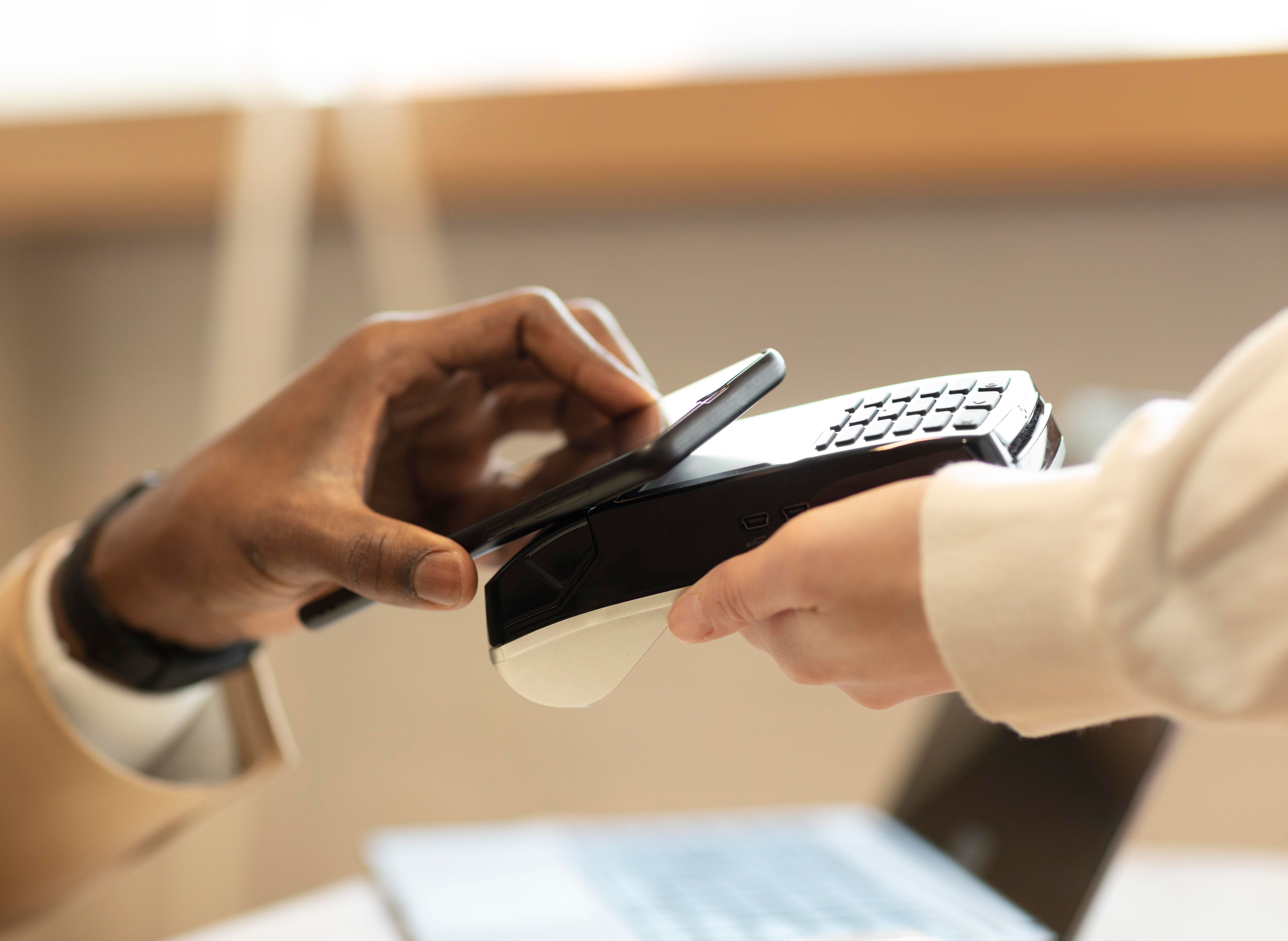 6925784093e0406c088c7ec8 man paying coffee shop with his phone