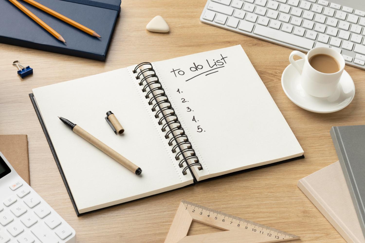 641433a1cf748a261a34396d flat lay notebook with list desk