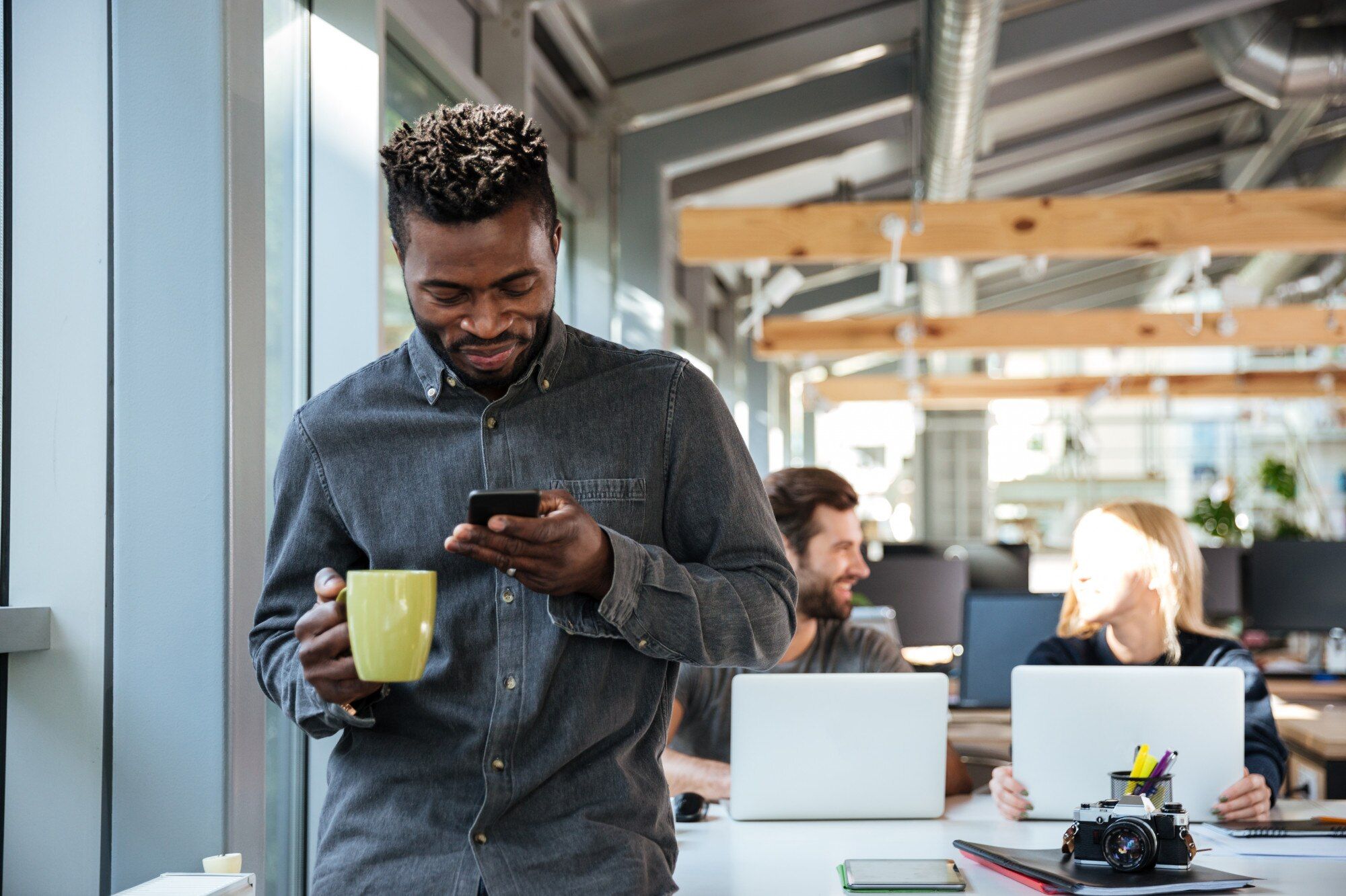 Young African professional speaking on the phone in an office