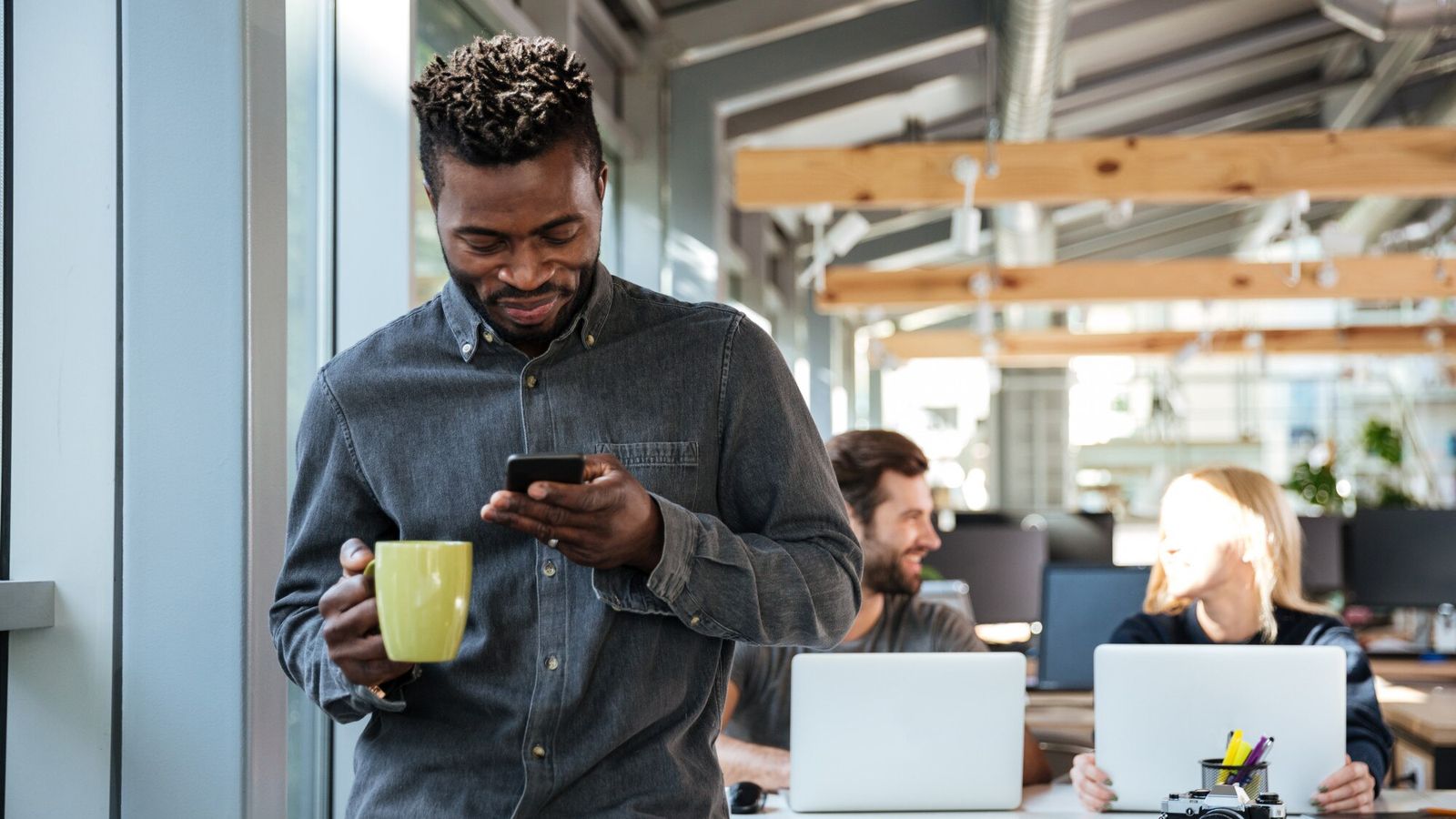 Young African professional speaking on the phone in an office