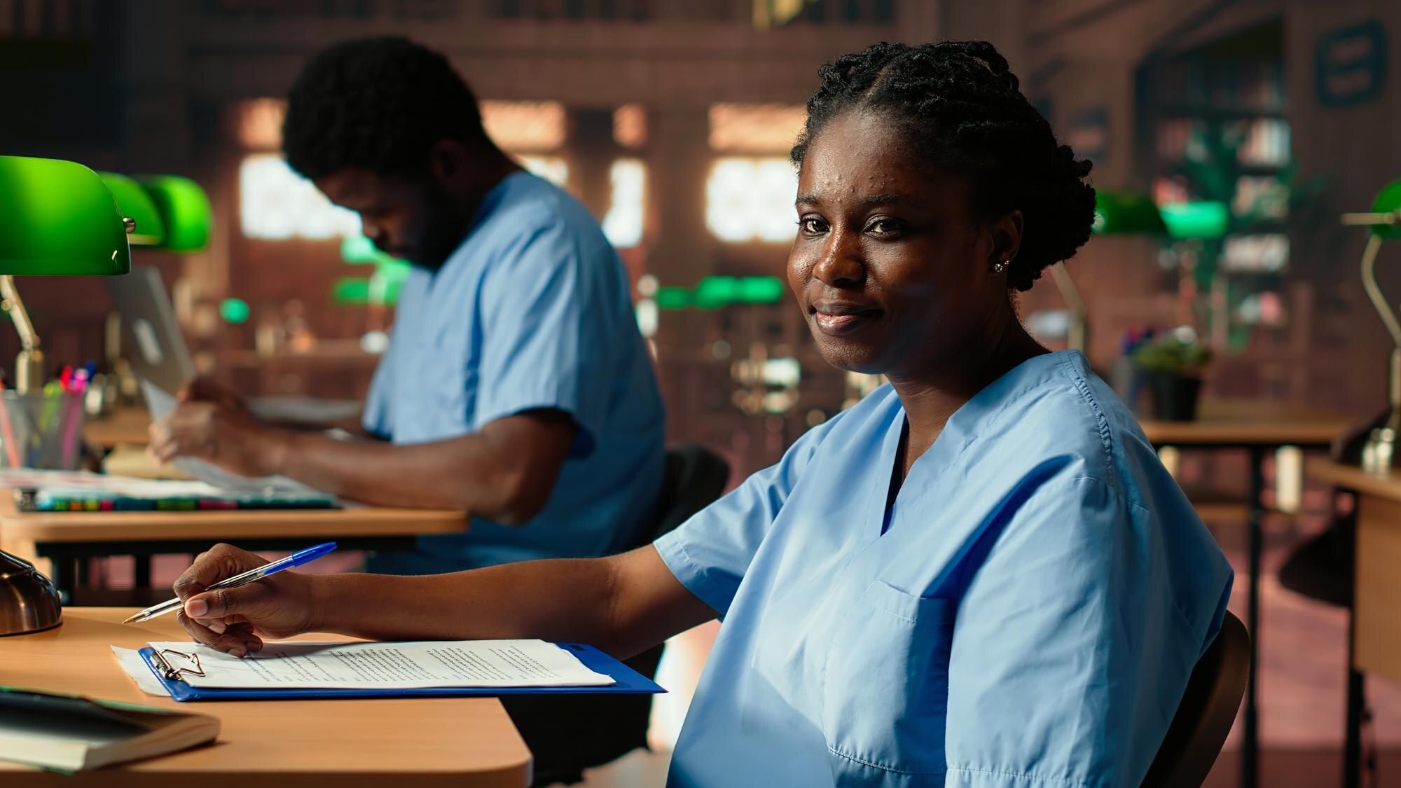 African American nurse in training reviewing anatomy case files