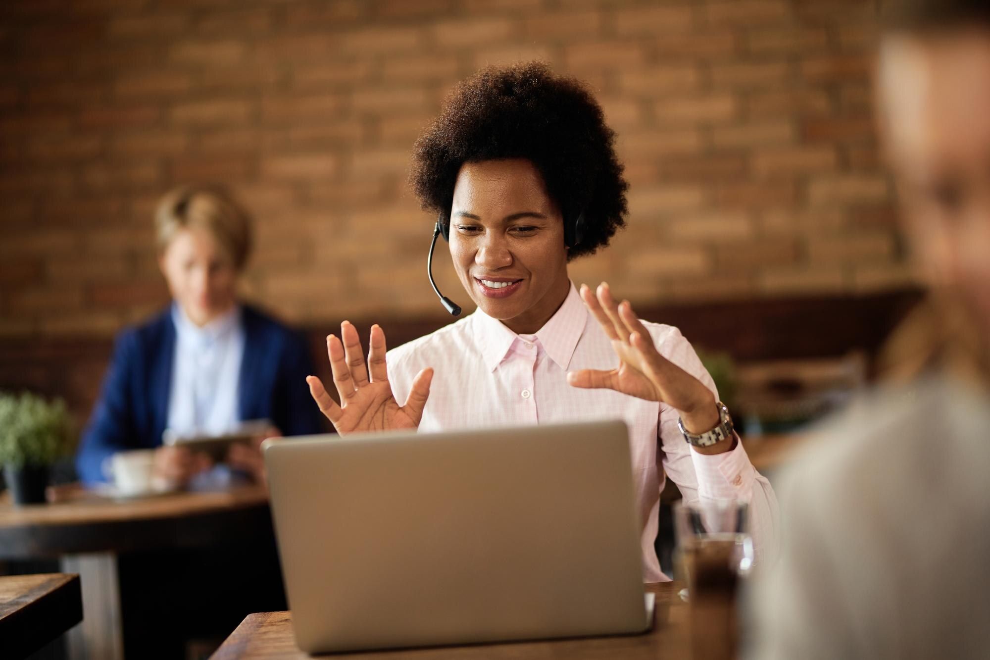 Black businesswoman making a video call over a laptop