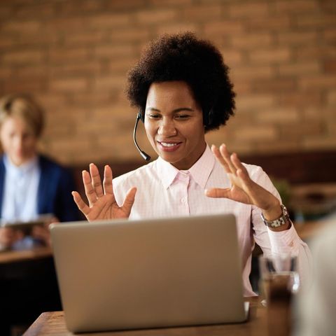 Black businesswoman making a video call over a laptop