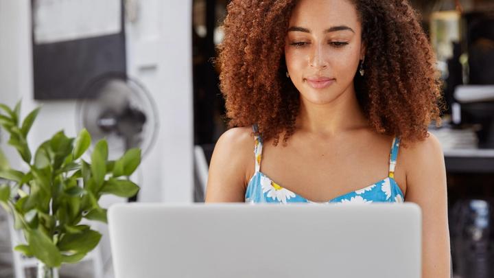 African American freelancer focused on her laptop