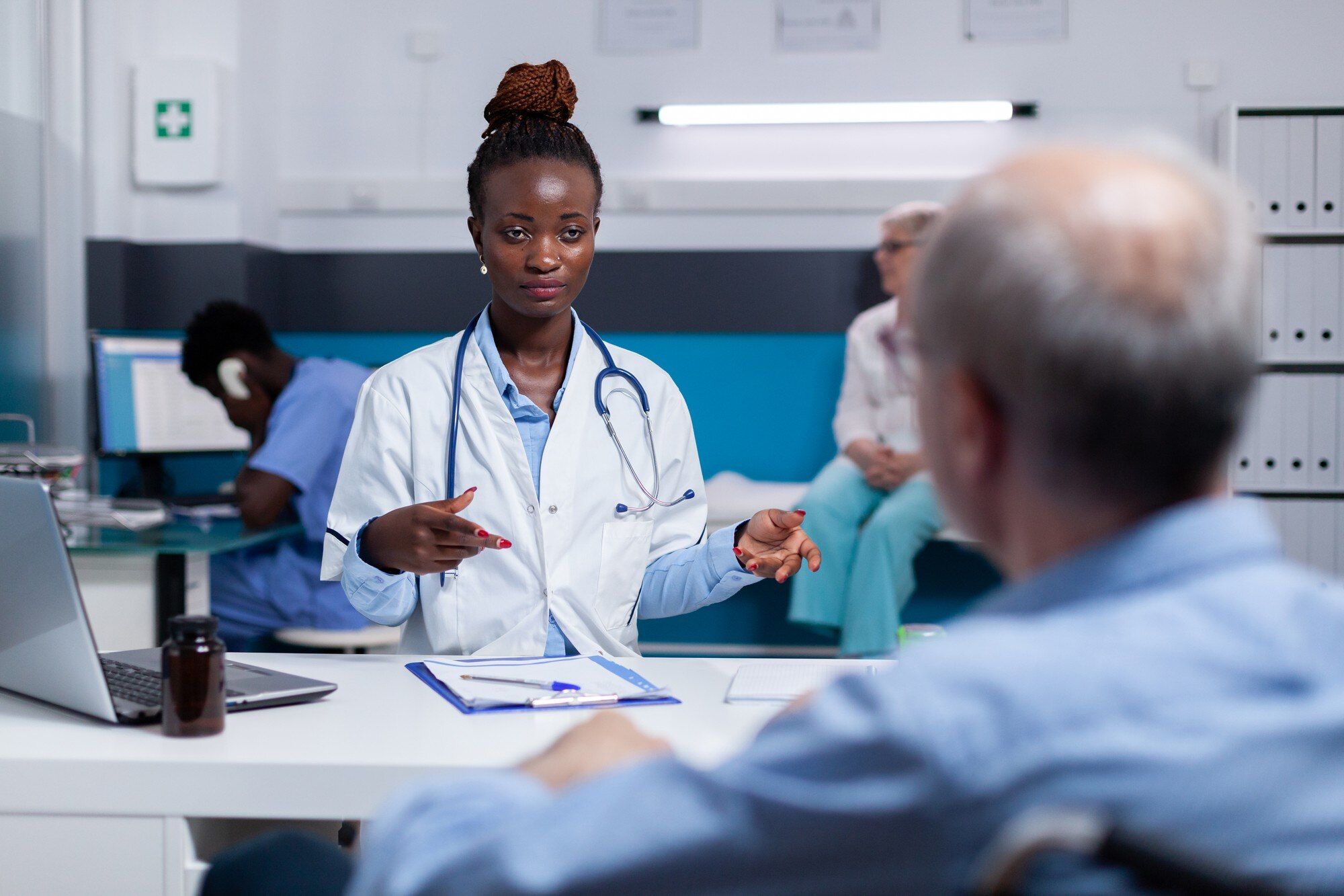 Doctor consulting with an older patient in a clinic setting
