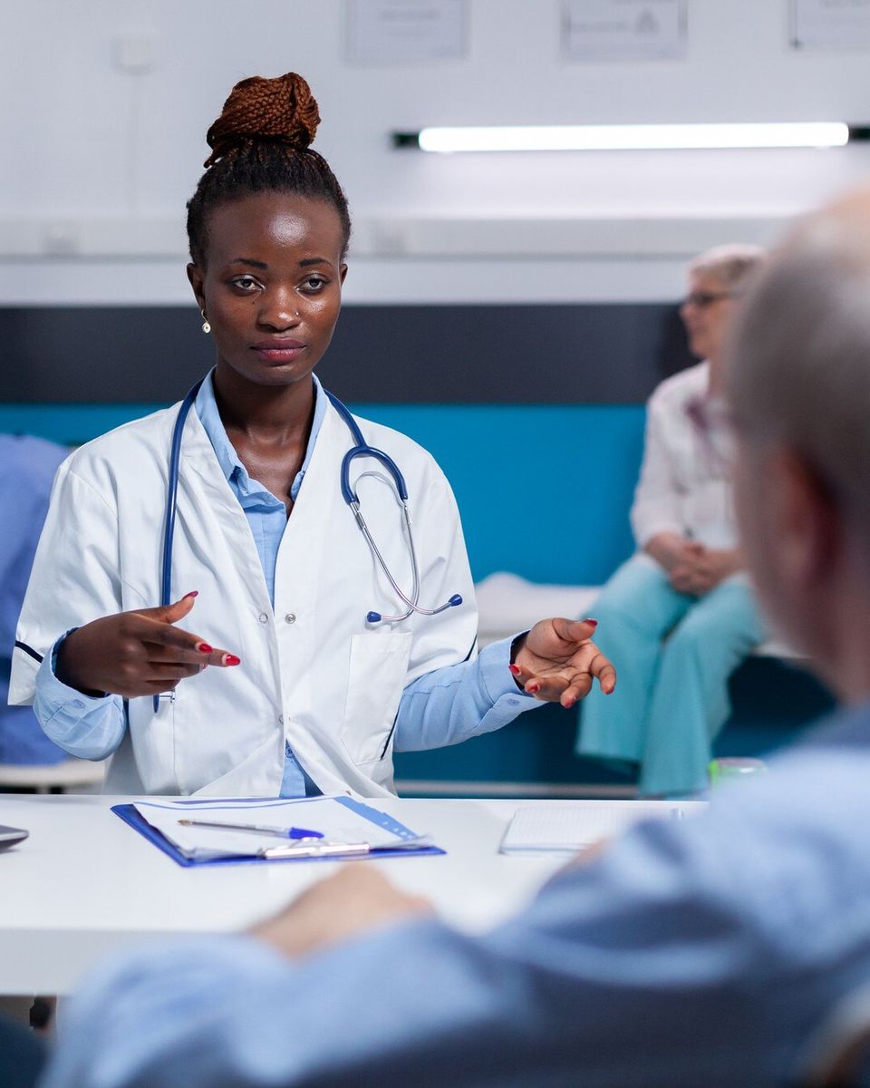 Doctor consulting with an older patient in a clinic setting