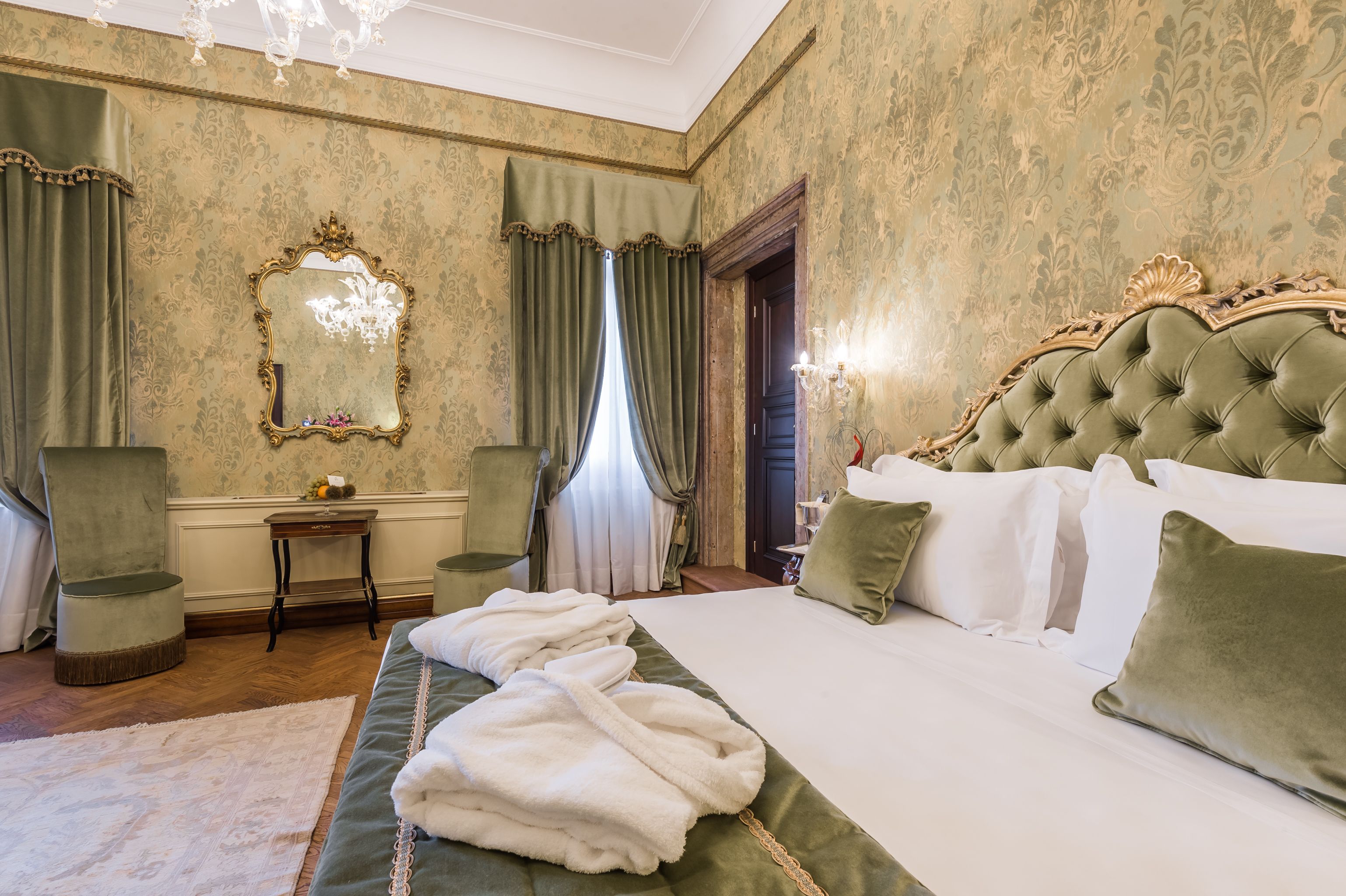 A hotel room with opuent Venetian decor