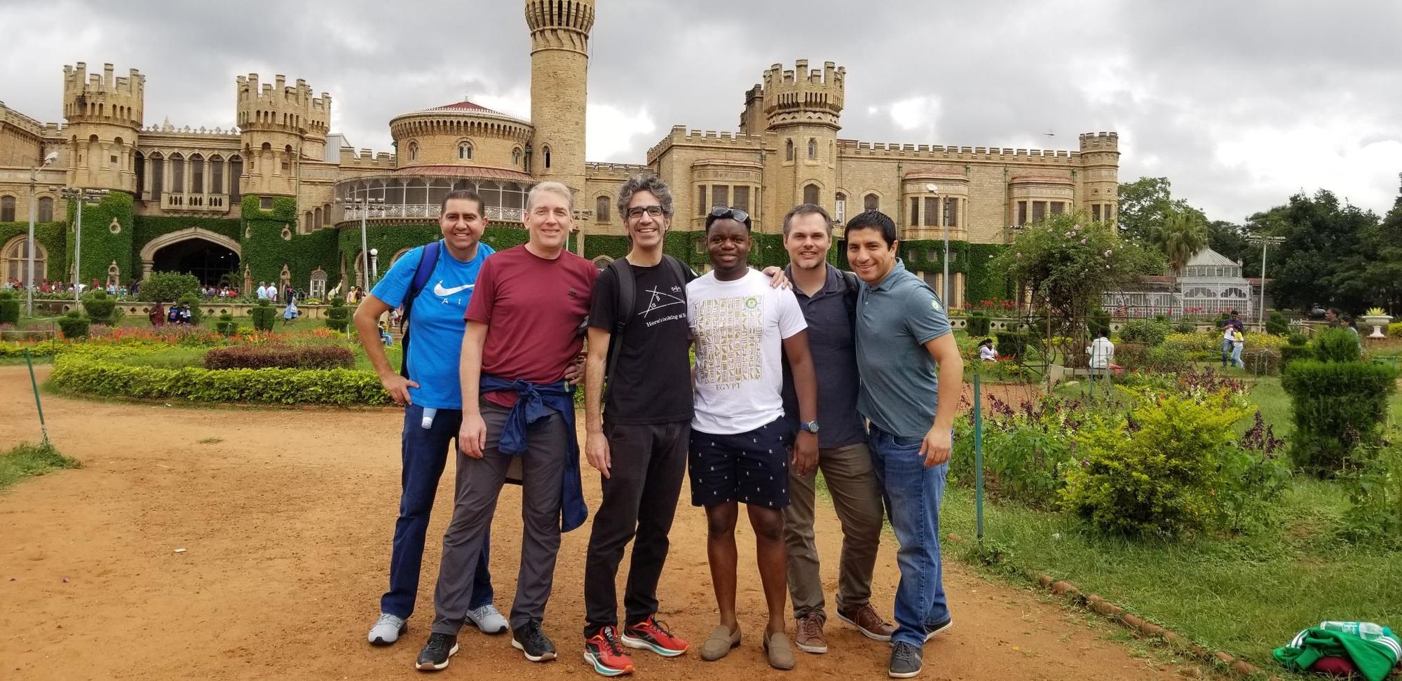 Cedrick with his friends made overseas in front of a castle.
