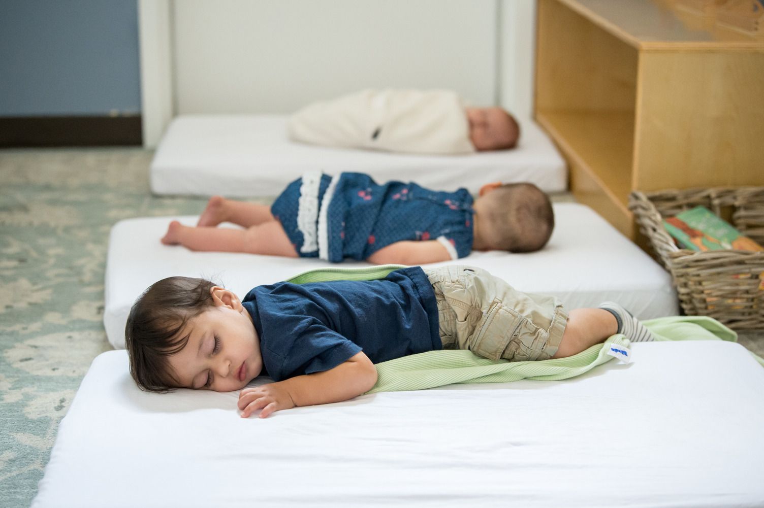 Baby sleeping on store floor mattress