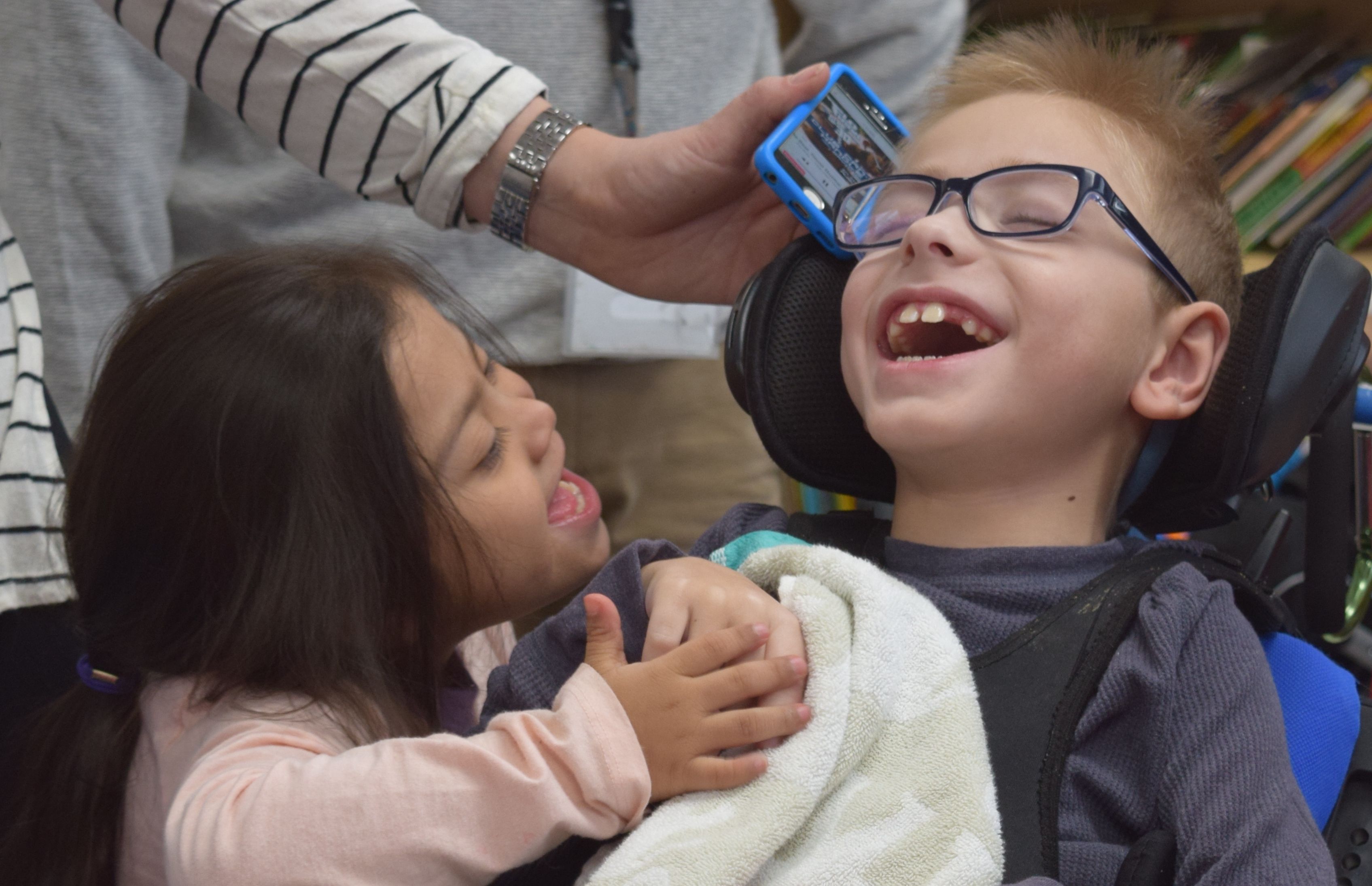 child in wheelchair having fun