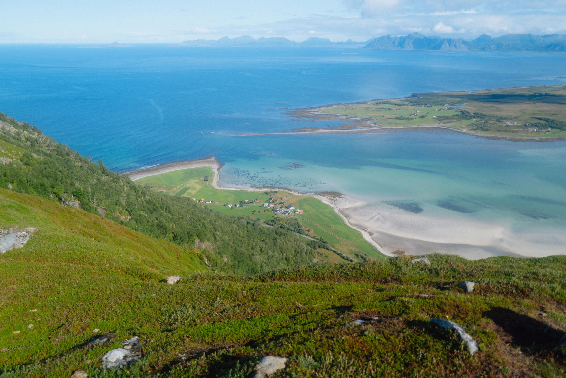 View from the sea from above with lush green fields