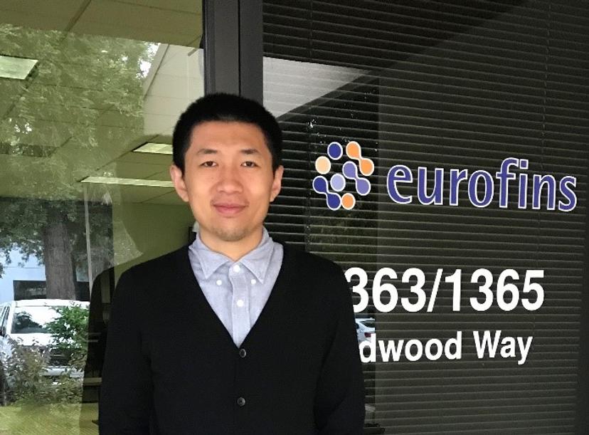 Dr. Hong You, standing in front of the front door of the Eurofins Supplement Analysis Center