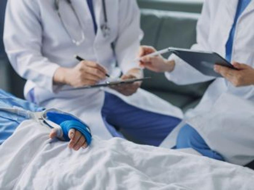 doctors sitting at a patients bedside at the point of care