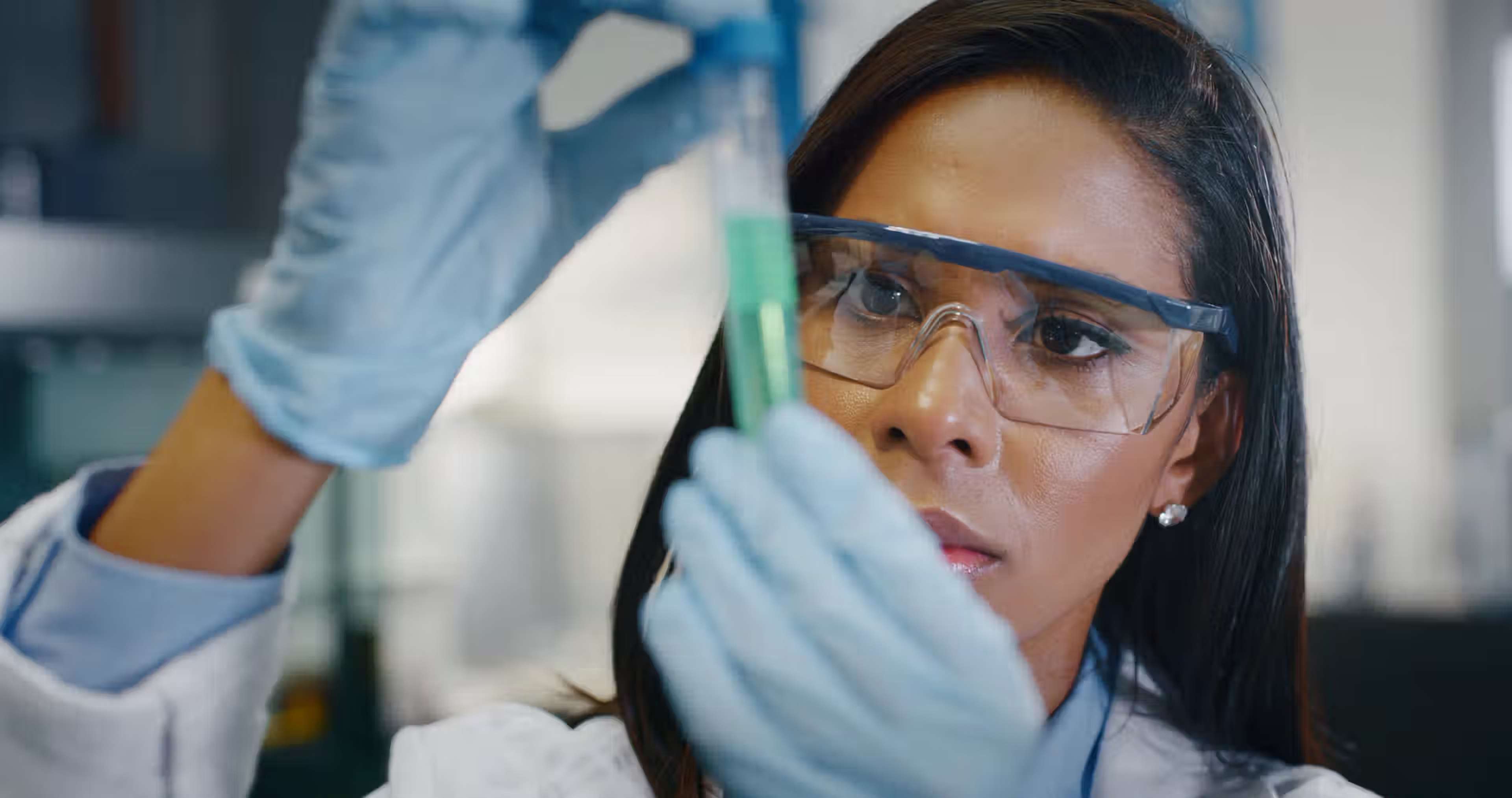SelectScience homepage - Female scientist inspecting test tube
