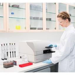 Fluoroskan in the lab with scientist loading plate