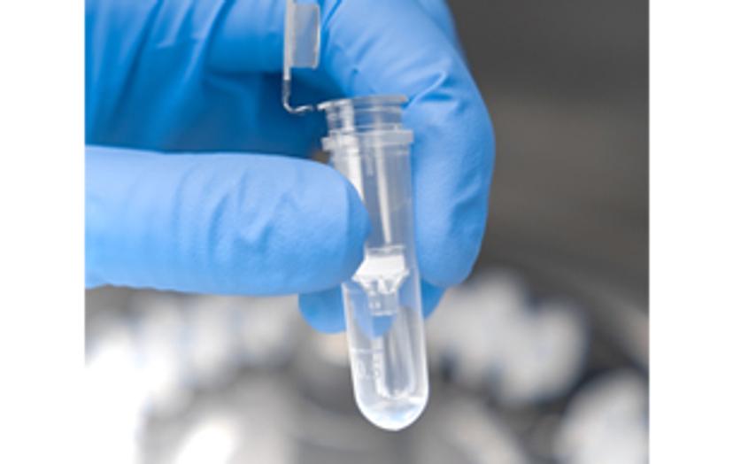 Scientist holding a SPINeasy nucleic acid kit