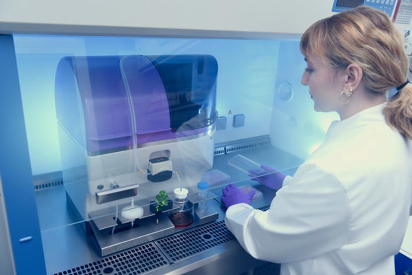 Image of a scientist working with the the VIPS PRO in a biosafety cabinet