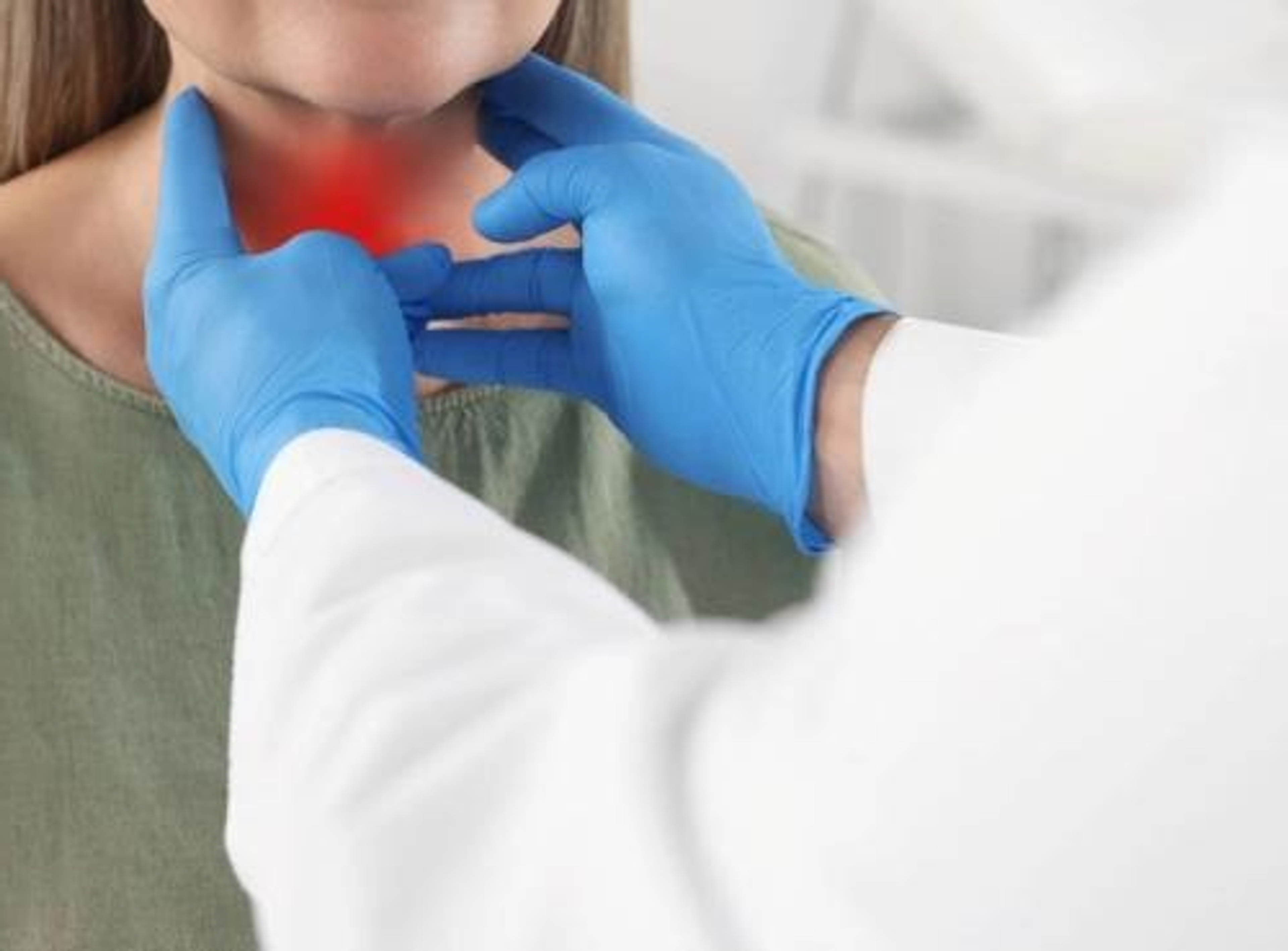 A doctor checks a patients thyroid for Graves' Disease