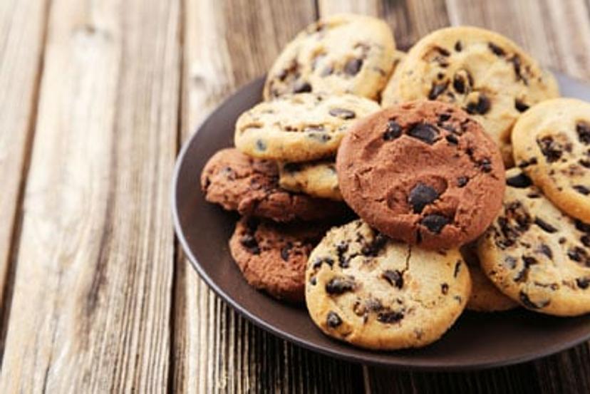 Chocolate chip cookies on a grey plate and wood background