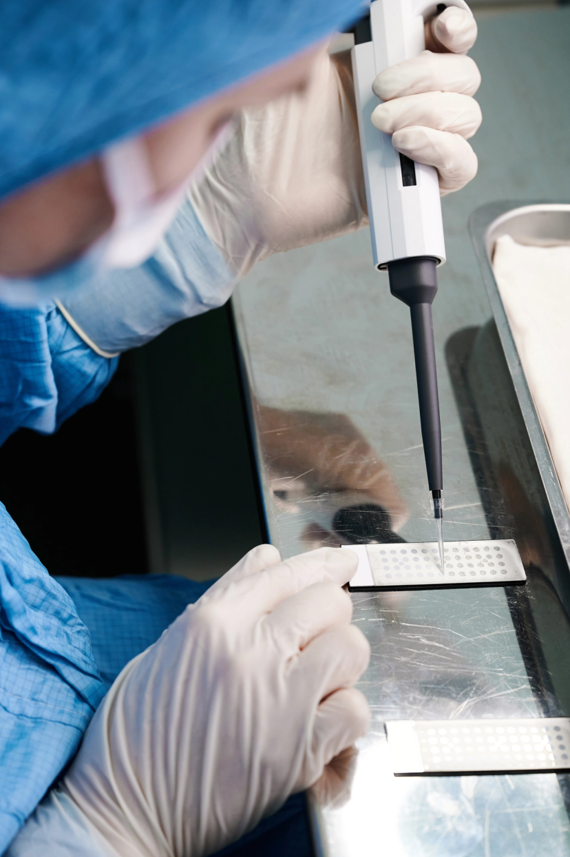Scientist loading mass spectrometry samples