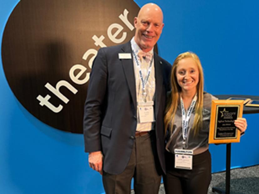 Jay Leech (left) presents Lauren Dostillio (right) with the Scientists' Choice Award for Virtual Event of the Year at SLAS 2022