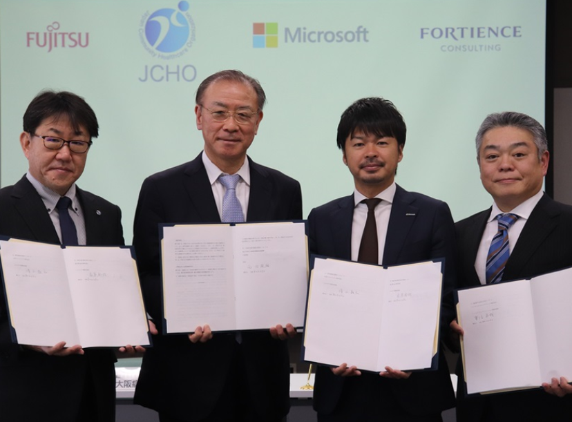 Hiroya Kuwahara, Fujitsu Japan, Toshirou Nishida, JCHO Osaka Hospital, Norihiro Shimizu, Microsoft Japan, and Takuya Shigenobu, Fortience Consulting, at the signing ceremony for this project