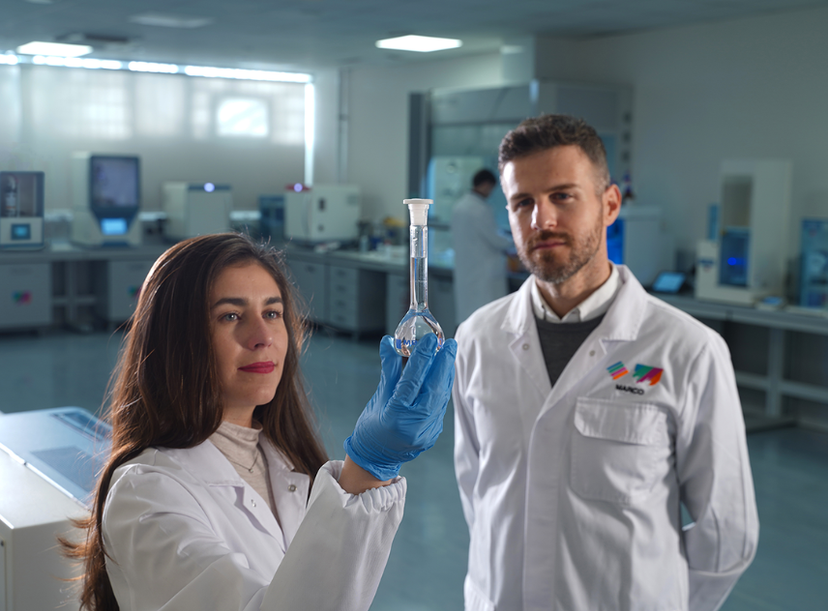 Scientists in food testing laboratory looking at a sample in test tube - SelectScience Milestone guest editorial article