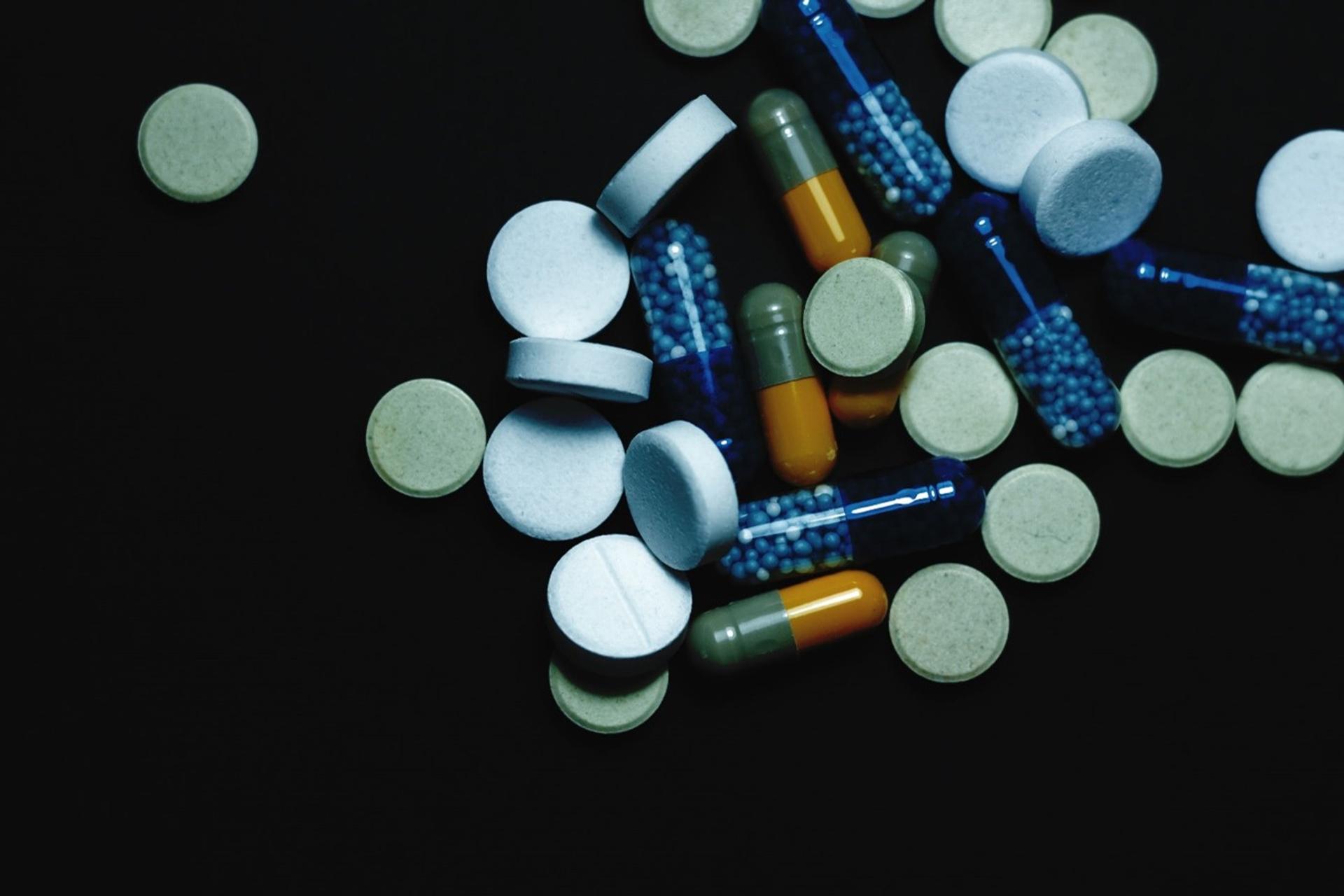 An image to show a collection of human medications, including various pills and loose capsules