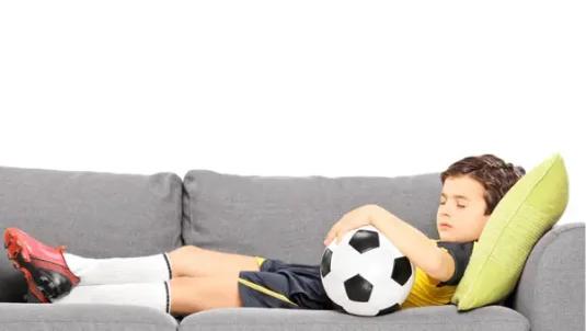Youth athlete lay down on a sofa