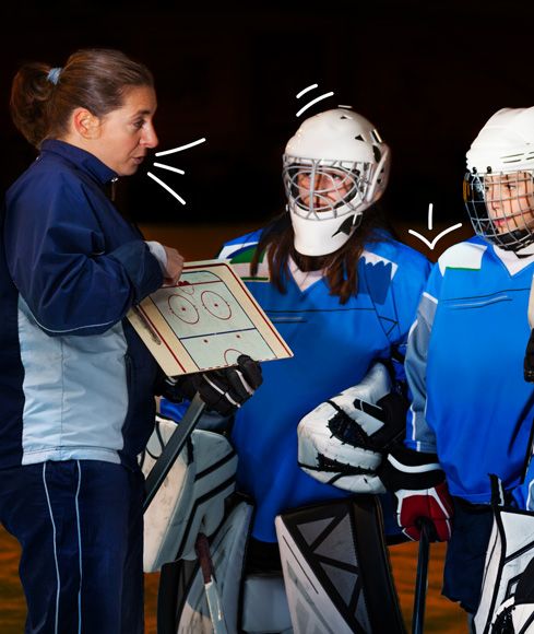 Hockey coach talking to her players