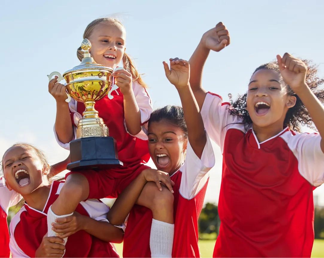 Joyful female youth athletes winning a game