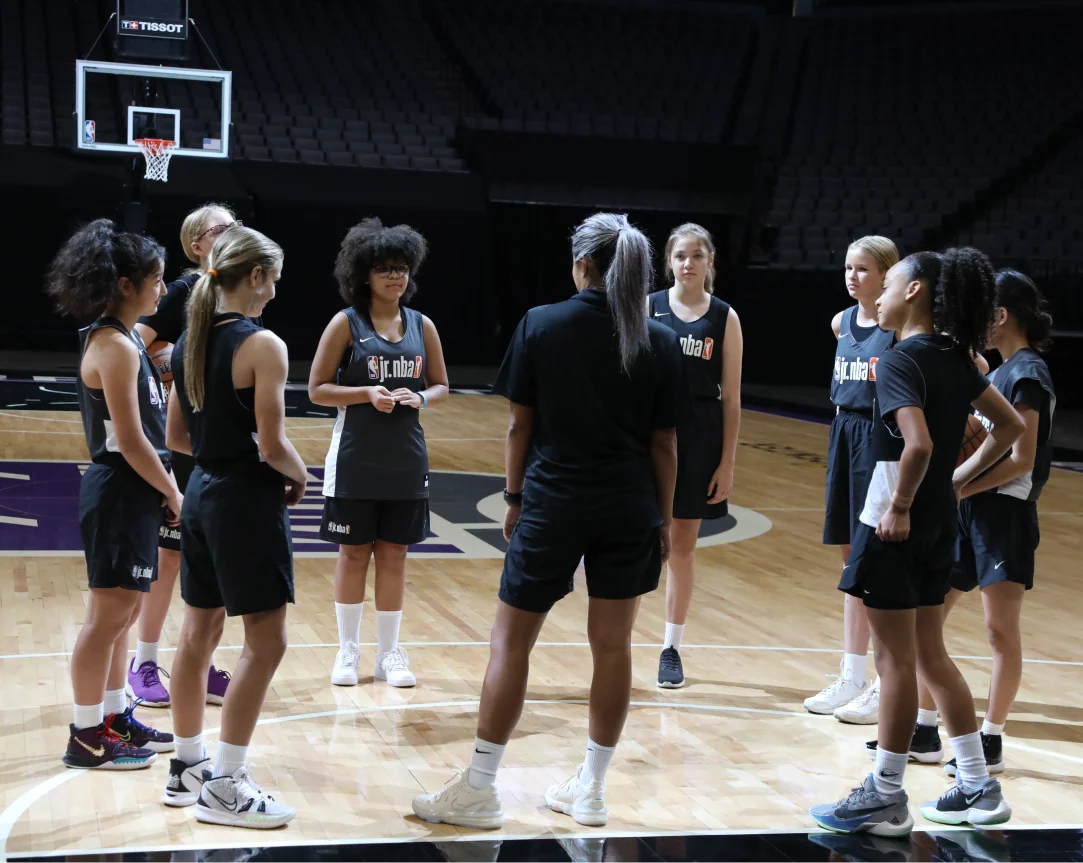 Youth girl athletes playing basketball